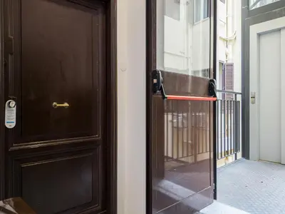 a wooden door with a glass window on a building at The Best Rent - One-bedroom flat in Tritone area in Rome