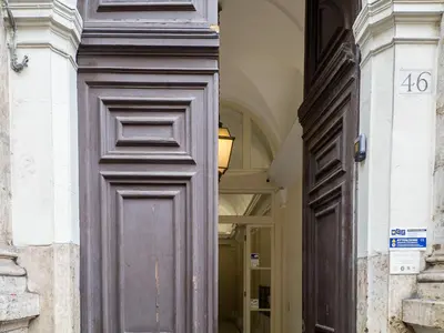 a large wooden door in a building at The Best Rent - One-bedroom flat in Tritone area in Rome