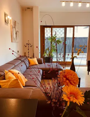 a living room with a couch and flowers on a table at My Suite in Vatican - big terrace in Rome