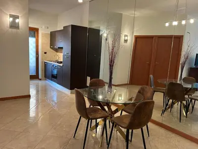a kitchen and dining room with a glass table and chairs at My Suite in Vatican - big terrace in Rome