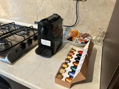 a box of donuts sitting on a counter next to a stove at My Suite in Vatican - big terrace in Rome
