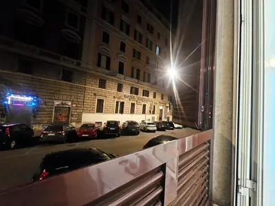 a view of a city street at night from a window at Check in Rome in Rome