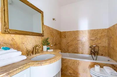 a bathroom with a sink and a tub and a mirror at iFlat Vatican & Navona apartment with nice view in Rome