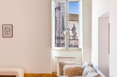 a living room with a couch and a window at iFlat Vatican & Navona apartment with nice view in Rome