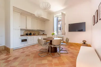 a kitchen and dining room with a table and chairs at iFlat Vatican & Navona apartment with nice view in Rome