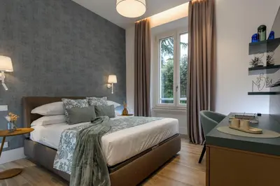 a bedroom with a bed and a desk and a window at PO1 Augusto - PO2 Cesare - PO3 Nerone in Rome