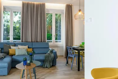 a living room with a blue couch and a table at PO1 Augusto - PO2 Cesare - PO3 Nerone in Rome