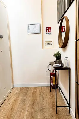 a room with a table and a mirror on the wall at Dave's Home In Trastevere in Rome