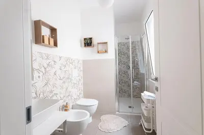 a white bathroom with a toilet and a shower at Dave's Home In Trastevere in Rome