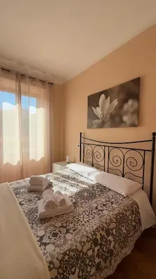 a bedroom with a bed with two towels on it at ColleVaticano Roma in Rome