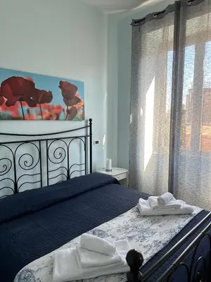 a bedroom with a bed with two towels on it at ColleVaticano Roma in Rome
