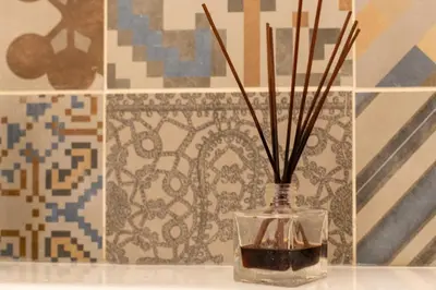 a glass vase with sticks in it on a table at iFlat A Peaceful Nest In The Eternal City in Rome