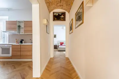 a hallway leading to a kitchen and a living room at iFlat A Peaceful Nest In The Eternal City in Rome