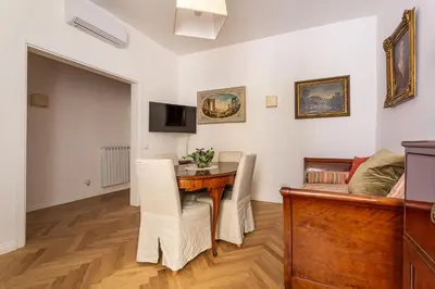 a living room with a table and a couch at iFlat A Peaceful Nest In The Eternal City in Rome