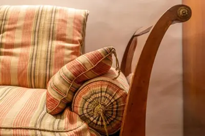 a pillow sitting on top of a chair at iFlat A Peaceful Nest In The Eternal City in Rome