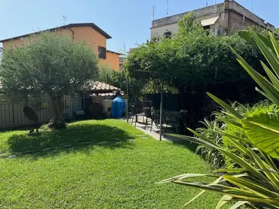 a garden with a person standing in a yard at Casa indipendente con vista acquedotto romano in Rome