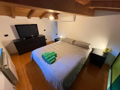 a bedroom with a large bed with a flat screen tv at Casa indipendente con vista acquedotto romano in Rome