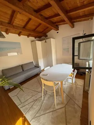 a living room with a table and a couch at Casa indipendente con vista acquedotto romano in Rome