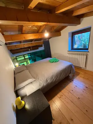 a bedroom with a bed in a room with wooden ceilings at Casa indipendente con vista acquedotto romano in Rome
