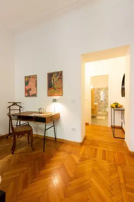 a room with a desk and a table in it at Trieste Guesthouse - ZENO 48 in Rome