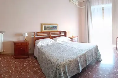 a bedroom with a bed with two pillows on it at Al settimo cielo RomaPigneto in Rome
