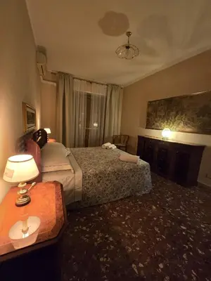 a hotel room with two beds and a table at Al settimo cielo RomaPigneto in Rome