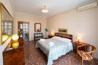 a bedroom with a bed and two tables and a mirror at Al settimo cielo RomaPigneto in Rome