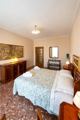 a bedroom with a large bed and a table at Al settimo cielo RomaPigneto in Rome