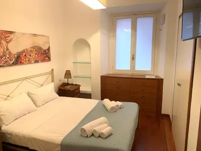 a bedroom with a bed with two towels on it at Harmony Apartment Via Veneto in Rome