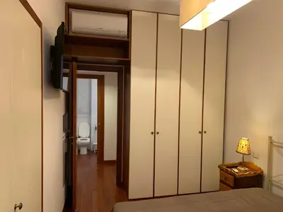 a bedroom with a bed and a bathroom with a toilet at Harmony Apartment Via Veneto in Rome