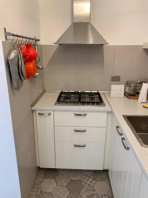 a kitchen with a stove top oven in a kitchen at Harmony Apartment Via Veneto in Rome