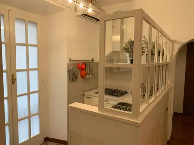 a white cabinet in a room with windows at Harmony Apartment Via Veneto in Rome