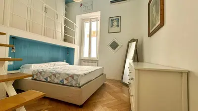 a small bedroom with a bed and a window at Rome Like Home in Rome