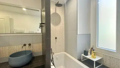 a bathroom with a blue tub and a sink at Rome Like Home in Rome