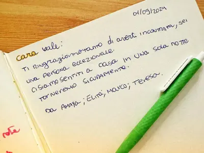 a green pen sitting on top of a piece of paper at Rome Like Home in Rome