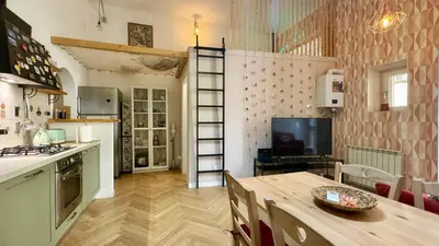 a kitchen with a table and a dining room at Rome Like Home in Rome
