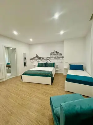 a bedroom with two beds and a couch at King's Place in Rome