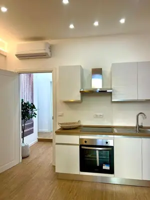 a kitchen with white cabinets and a sink at King's Place in Rome