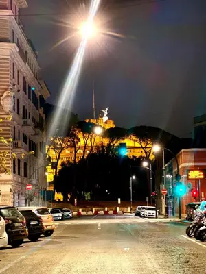 a street with a light on top of a building at King's Place in Rome