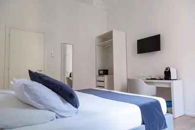 a hotel room with a bed and a mirror at Relais Borsieri in Rome
