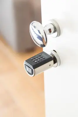 a key unlocking a door with a remote control at Relais Borsieri in Rome