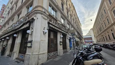 a row of scooters parked in front of a building at Eternal City House in Rome