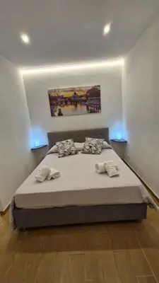 a bedroom with a large bed with two pillows at Eternal City House in Rome
