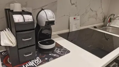 a coffee maker on a counter next to a sink at Eternal City House in Rome