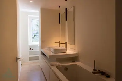 a bathroom with a tub and a sink and a mirror at Domus Consalvi - Ponte Milvio in Rome