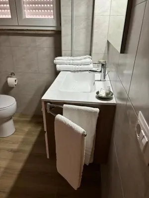 a bathroom with a sink and a toilet at Caos Calmo House in Rome