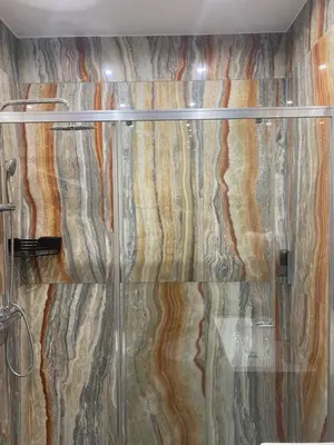 a shower with a glass curtain in a bathroom at Caos Calmo House in Rome