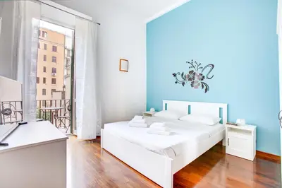 a white bedroom with a bed and a window at Casa a San Giovanni - Charming Flat in Rome in Rome