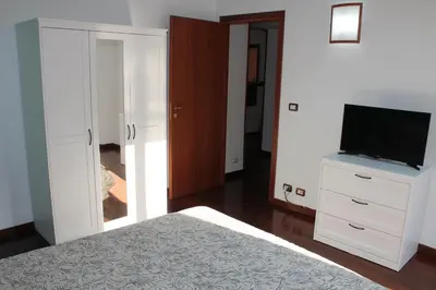 a bedroom with a bed and a flat screen tv at Casa a San Giovanni - Charming Flat in Rome in Rome