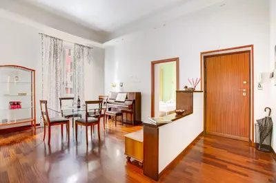a living room with a table and a dining room at Casa a San Giovanni - Charming Flat in Rome in Rome